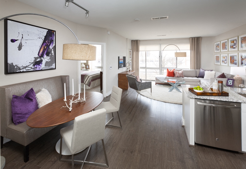 a living room and dining room with a table and chairs