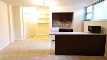 A room with a brown counter and a stone wall. at 2400 Pennsylvania Avenue Apartments, Washington, DC,20037