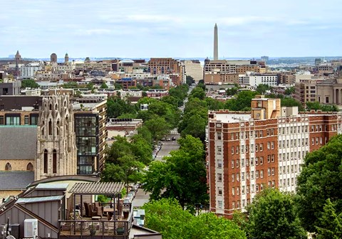 A cityscape with a tall obelisk in the distance.