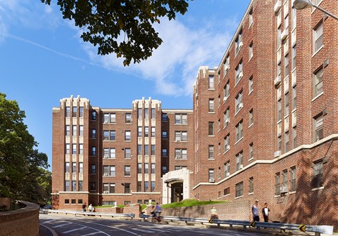 A large red brick building with a white arched entrance.