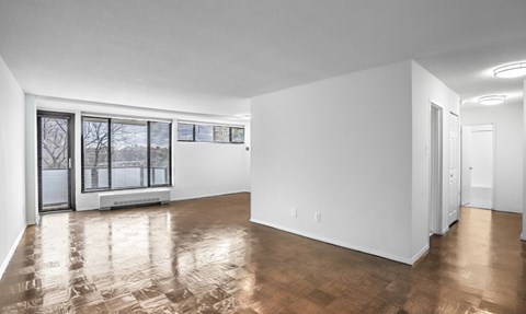 A spacious room with wooden flooring and white walls. at Calvert House Apartments, Washington, DC, 20008