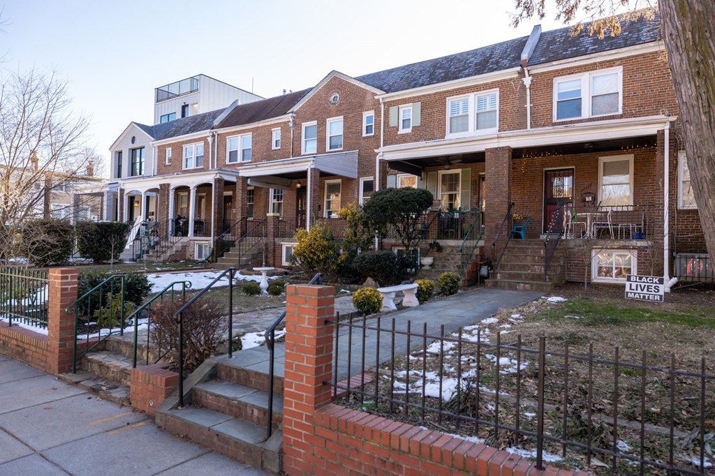 the front yard of a home has snow on the ground