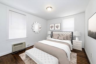 a bedroom with a bed and two windows