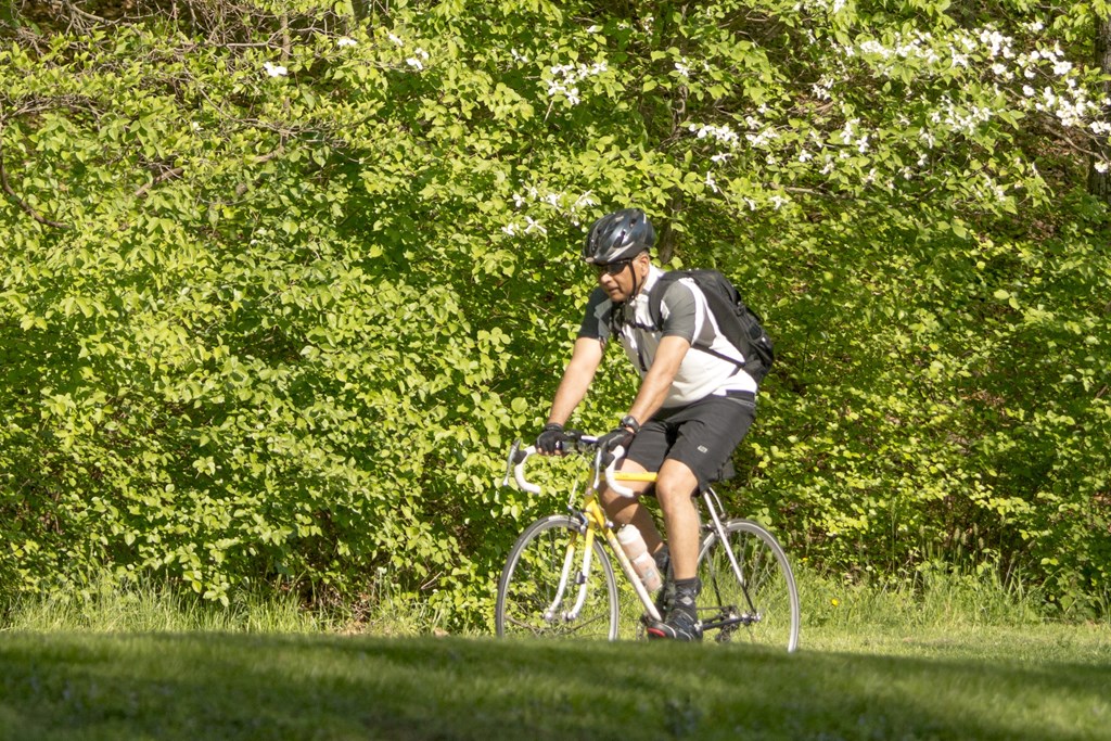 a man riding a bike in the grass