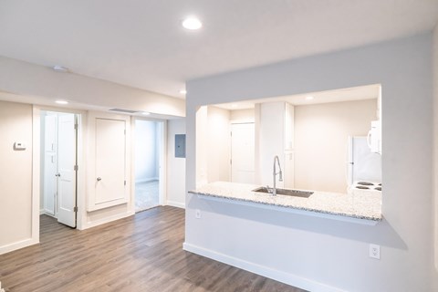A modern kitchen with a sink and a large mirror.