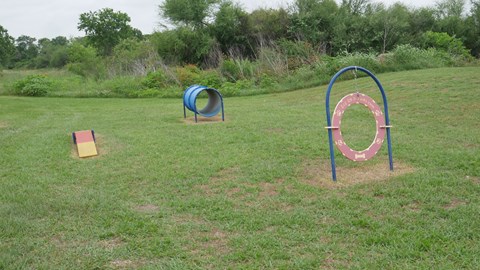 A playground with a blue and red ring and a yellow block.