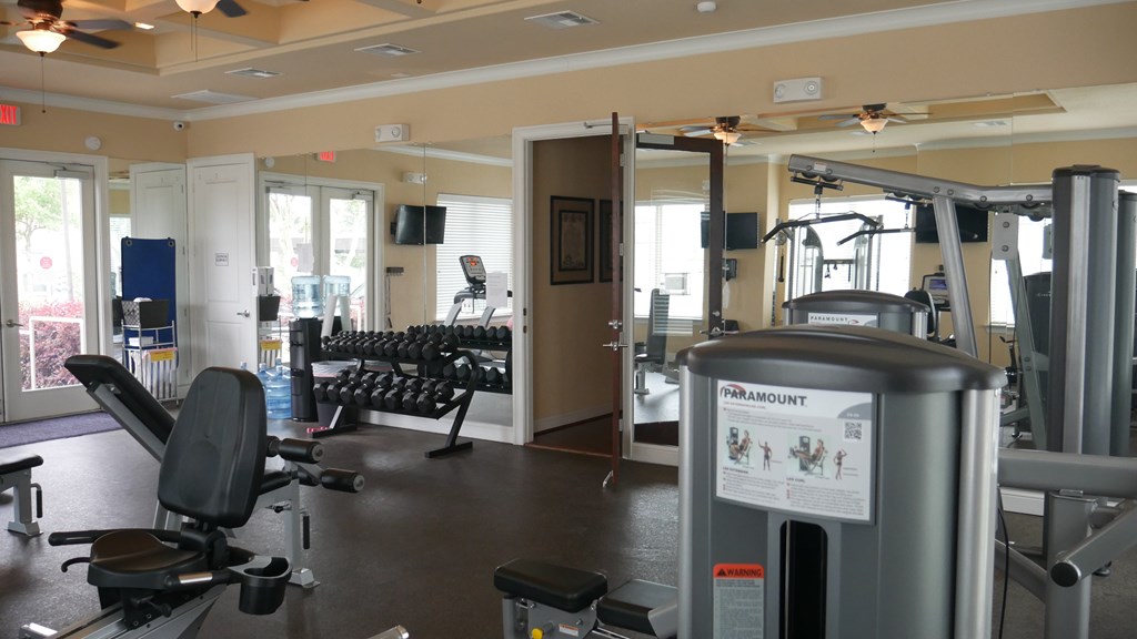 A gym with a variety of equipment including a treadmill.