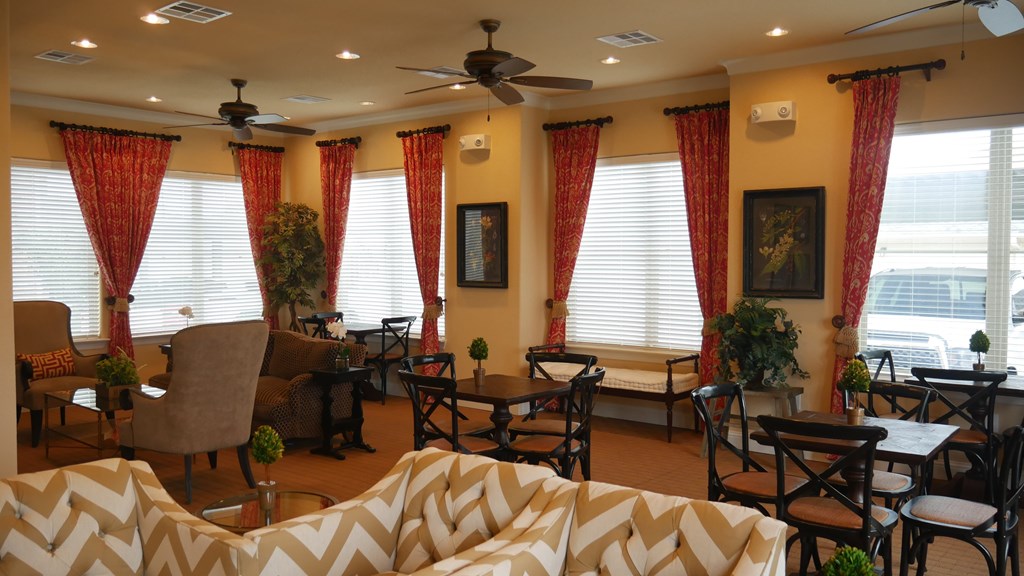 A living room with a white sofa and a ceiling fan.