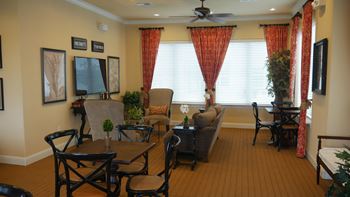 A living room with a dining table and chairs.