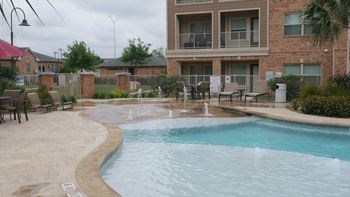A pool with a fountain in the middle of it.
