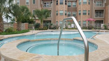 A large outdoor swimming pool with a slide.