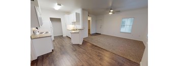 A room with wooden floors and white walls.