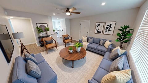 A living room with a blue couch and a wooden coffee table.