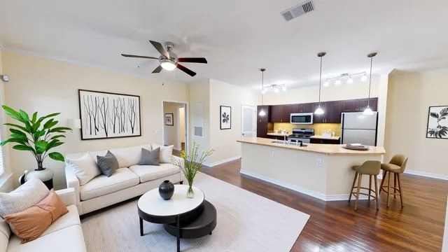 A living room with a white couch and a coffee table.