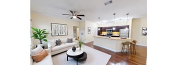 A living room with a white couch and a coffee table.
