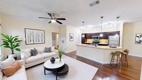 A living room with a white couch and a coffee table.