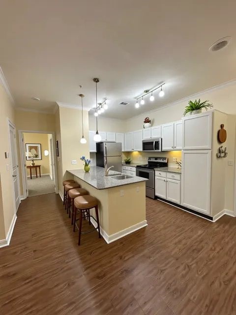 A kitchen with a bar area and stools.