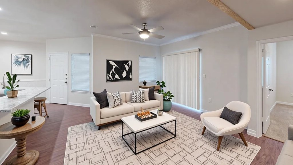 A living room with a white couch, a coffee table, and a rug.