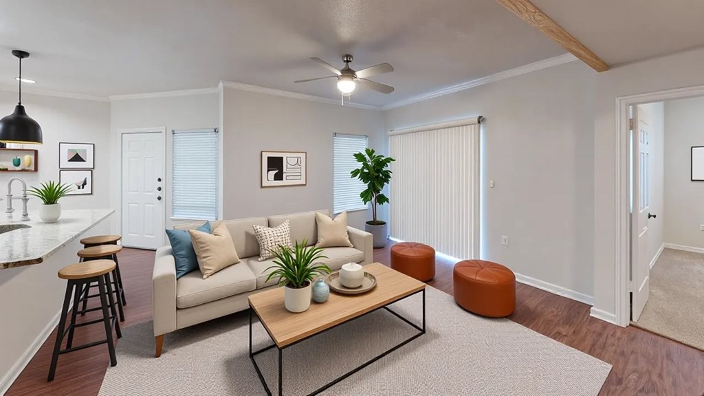 A living room with a couch, a table, and a plant.