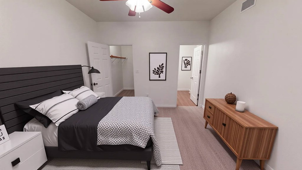 A bedroom with a bed, nightstand, and a wooden cabinet.