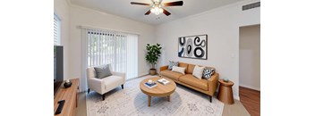 A living room with a couch, chair, and coffee table.