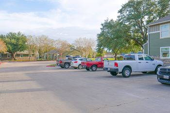 A parking lot with several trucks and cars.