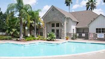A house with a pool in front of it.