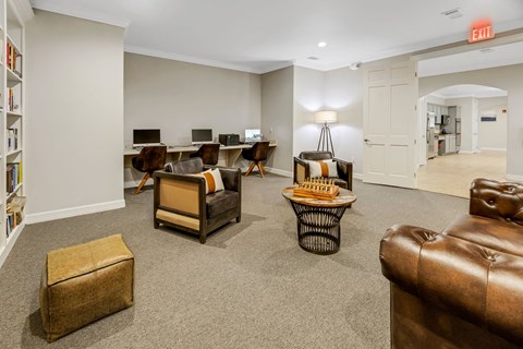 a living room with couches and chairs and a desk