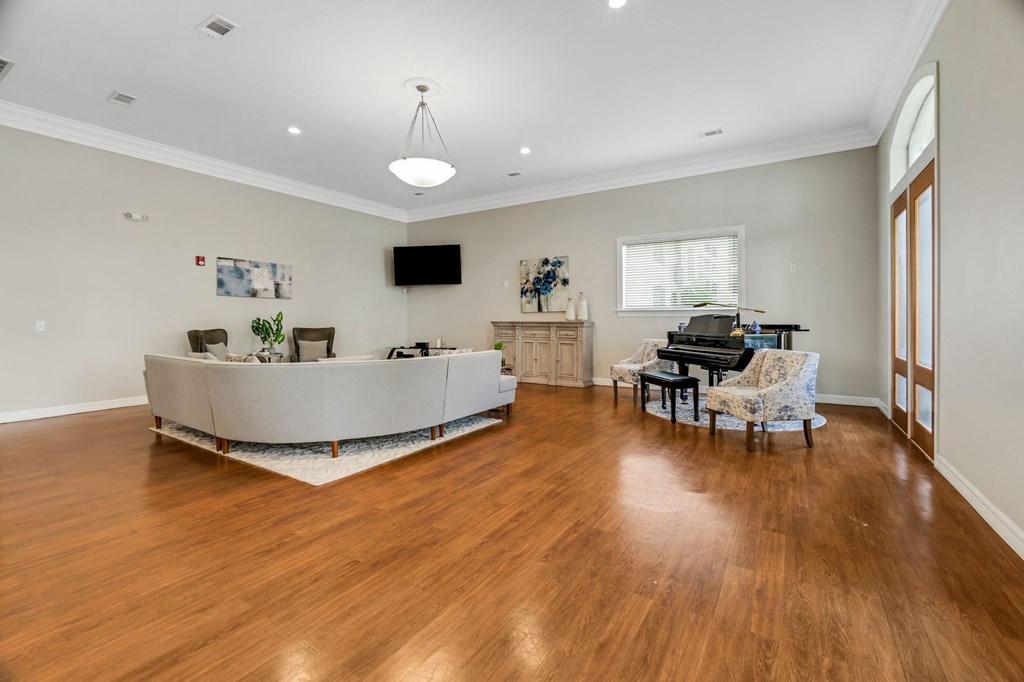 a living room with a couch and a piano
