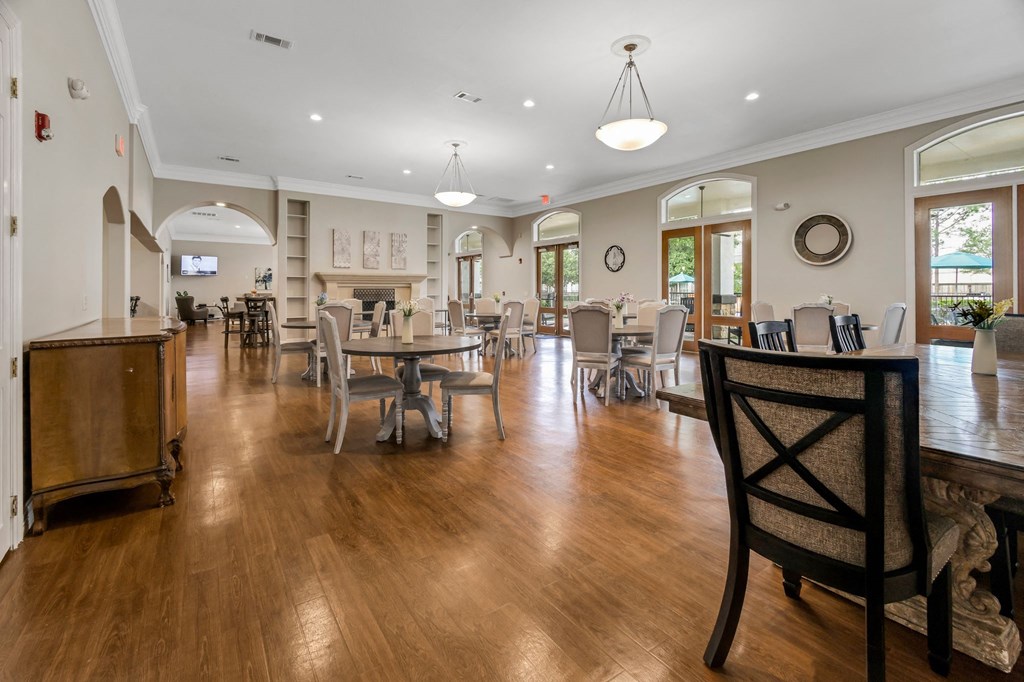 a large dining room with tables and chairs and a fireplace