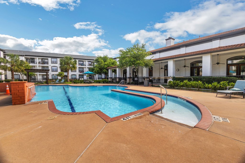 a swimming pool with a building in the background