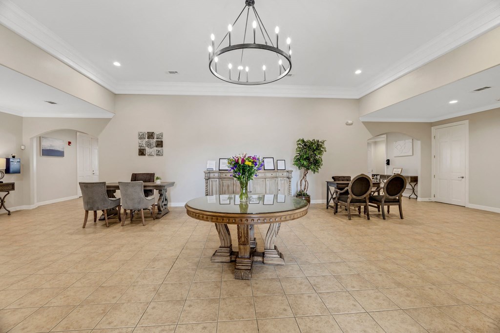 a dining room with a table and chairs and a chandelier