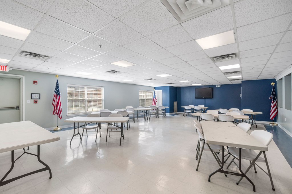 a dining room with tables and chairs and a tv