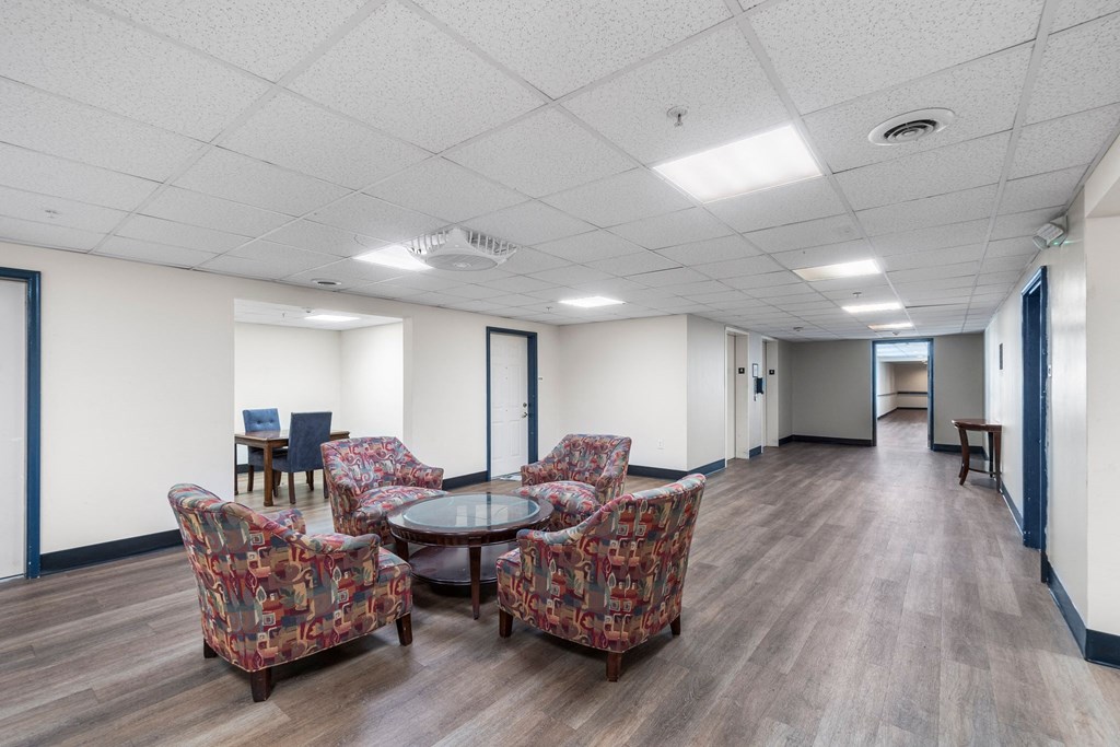 A room with a table and chairs.