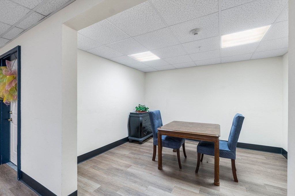 a dining room with a table and chairs and a tv