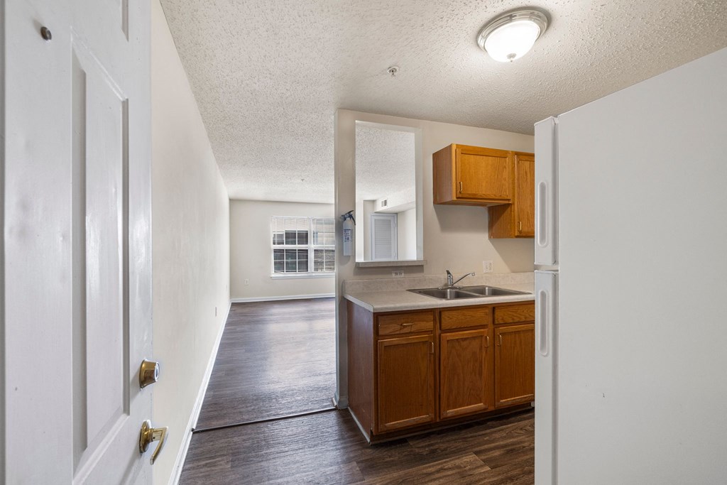 an empty kitchen with wooden cabinets and a sink