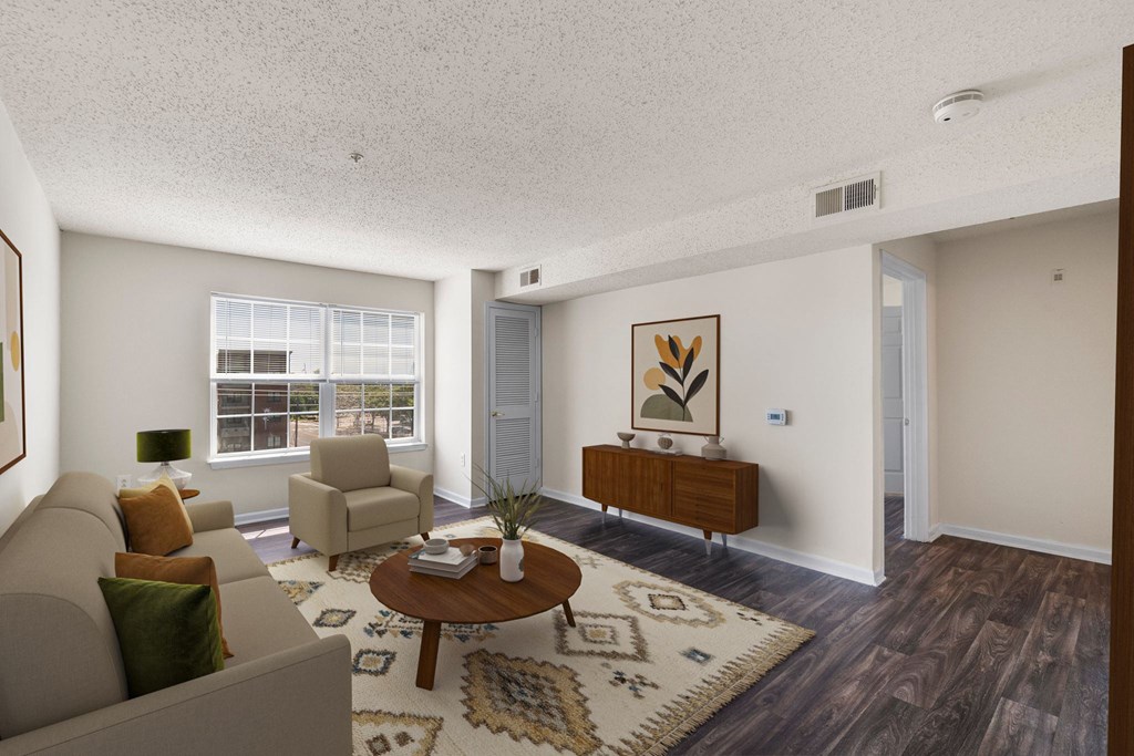 A living room with a brown coffee table and a beige couch.