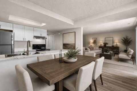 A modern kitchen with a dining table and chairs.