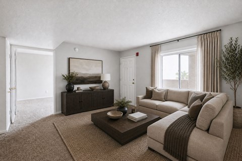 A living room with a brown sofa and a coffee table.