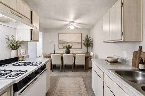 A modern kitchen with a dining table set for four.