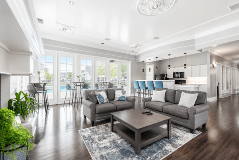 A living room with a grey sofa, a grey coffee table, and a white ceiling.