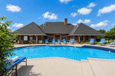A large house with a pool in front.