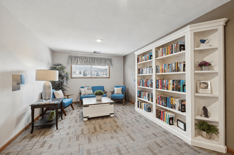 A living room with a bookshelf filled with books.
