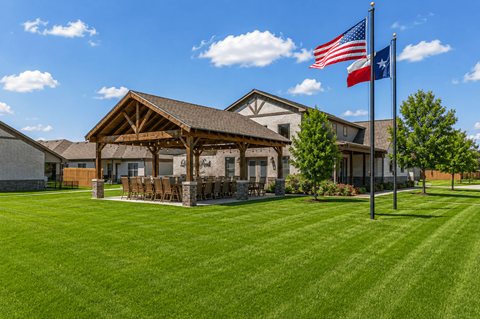 A house with a flag on the lawn.