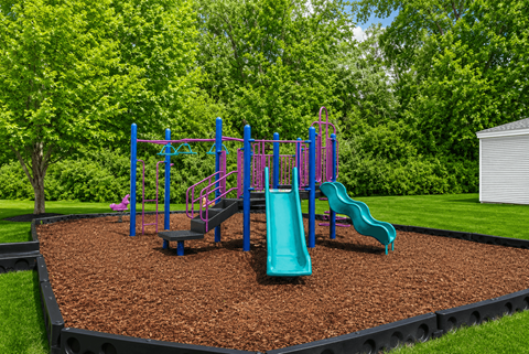 A playground with a blue and purple swing set and a green slide.