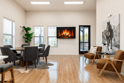 A modern living room with a fireplace and a dining table.