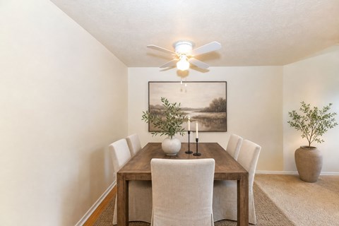 Dining room with wooden table and chairs at Stonetree Apartments, East Point, Georgia