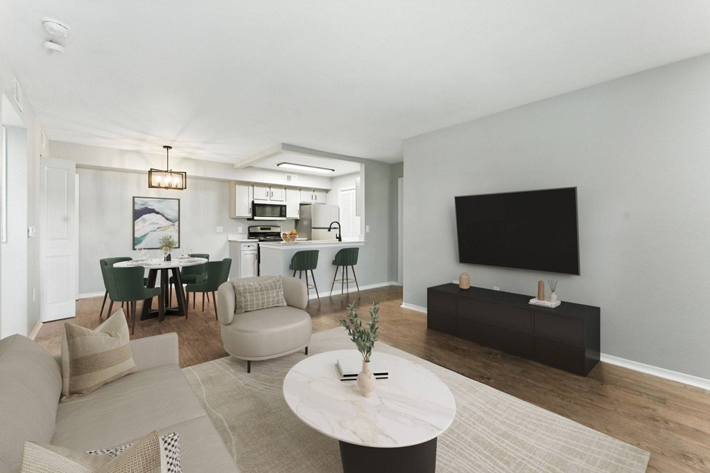 A modern living room with a dining area and a flat screen TV.
