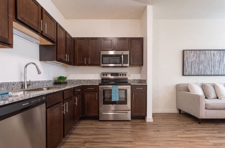 a kitchen with stainless steel appliances and wooden cabinets