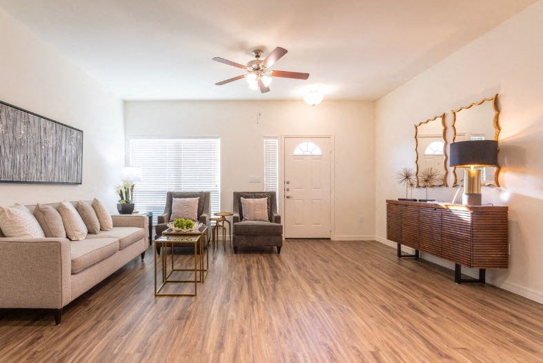 a living room with furniture and a ceiling fan